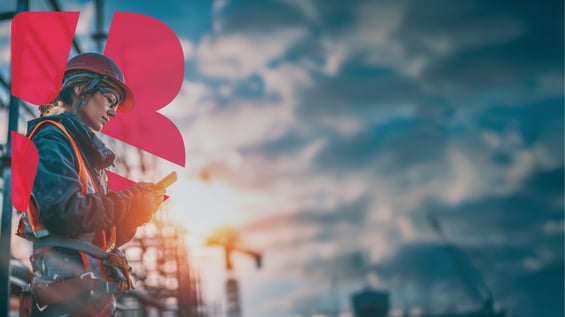 A female construction worker using her cell phone with the BRIX logo in the background.